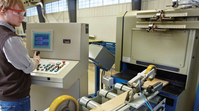 A student using precision equipment at the Wood Technology Center of Excellence.