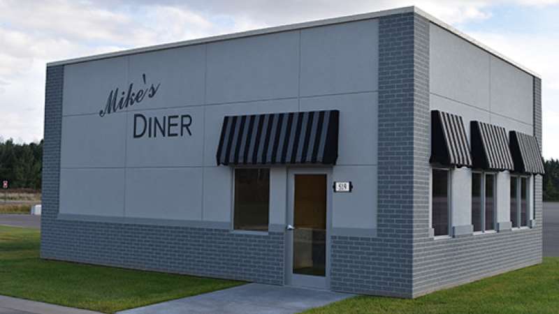 A mock restaurant named called “Mike's Diner” with 4 windows and one door.