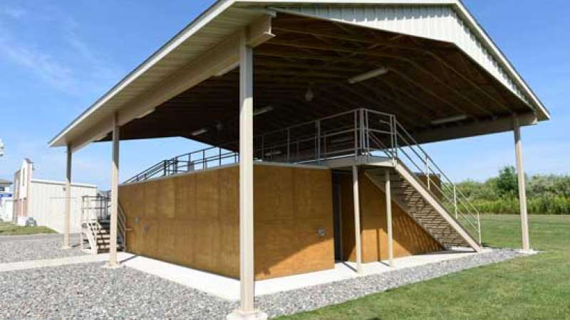 A building set up for search and rescue training, with several rooms made of plywood and a catwalk above.