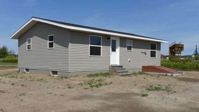 A single family home set up in a field.