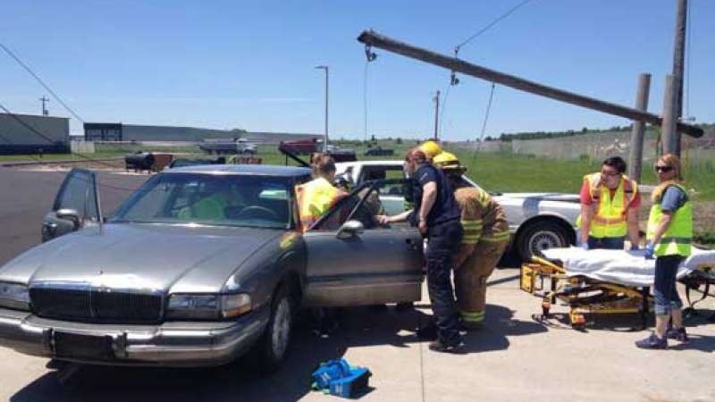Several EMS workers training in a car with downed power lines scenario.