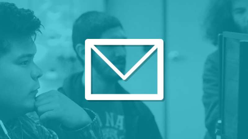 A graphic of an envelope is overlayed on top of an image of three students doing work on computers
