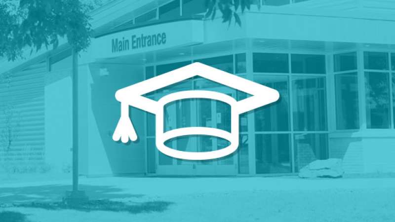 A symbol of a graduation hat is overlayed on top of an image of the NTC Wausau Campus main entrance