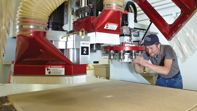 A student apprentice is operating a machine