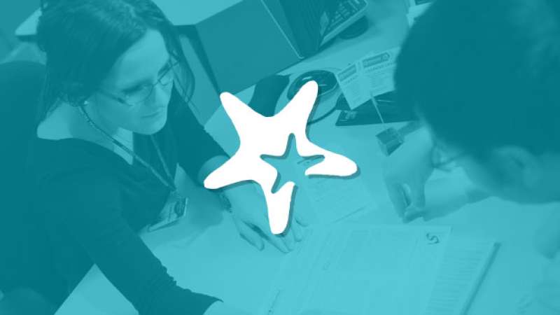 Starfish logo overlayed on top of student getting help from a student services employee