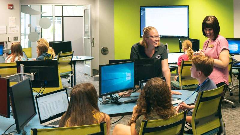 A group of prospective students listen to NTC staff while seated in a room near the iTEC during a tour of the NTC Wausau Campus.