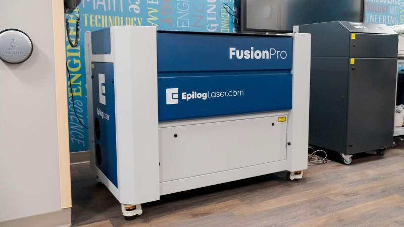 A large, FusionPro laser engraver sitting in a corner of the STEM Center.