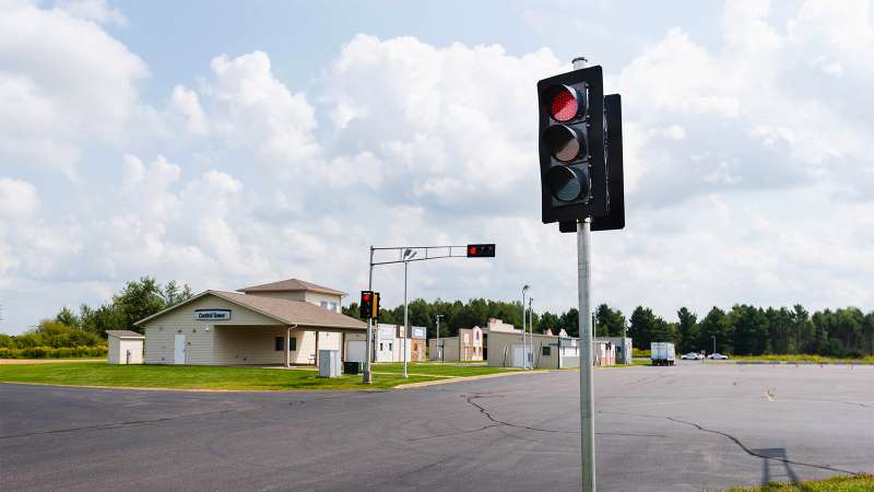 A view of a DOT regulated traffic standards area, including traffic lights at an intersection.