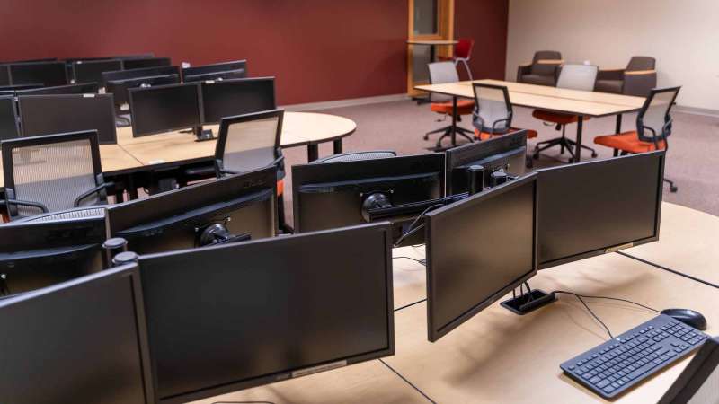 Several desktop computers at tables in the Community Technology Center