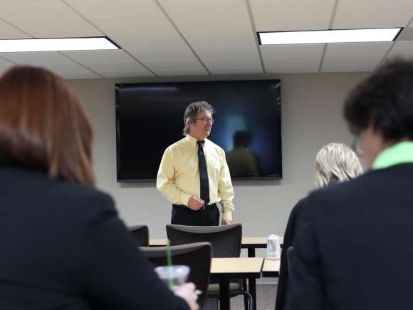 Business instructor teaching business people.