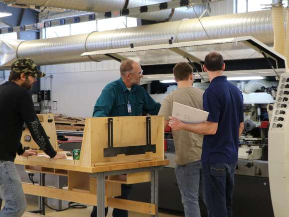 Wood Technology students learning about a machine