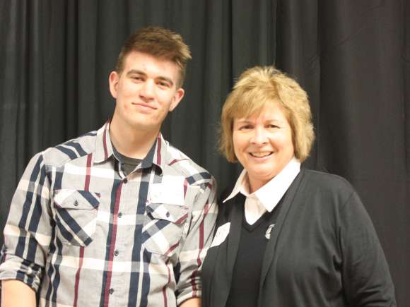 Lori Weyers gives a student the Lori Weyers Presidential Scholarship