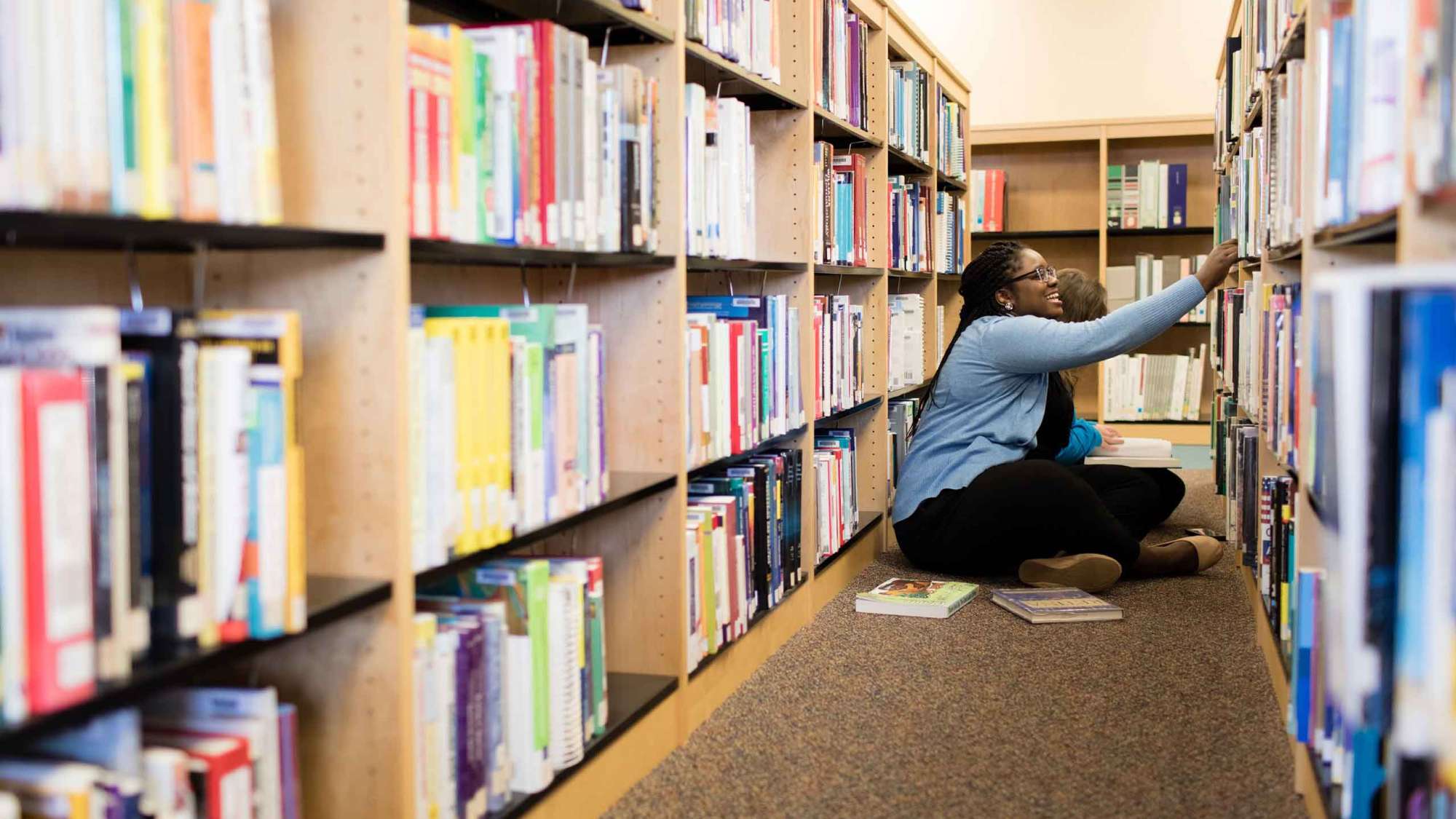 Students in the library searching for books