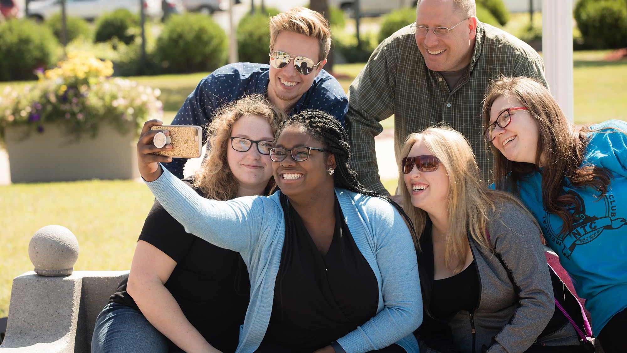 A group of students taking a selfie outside