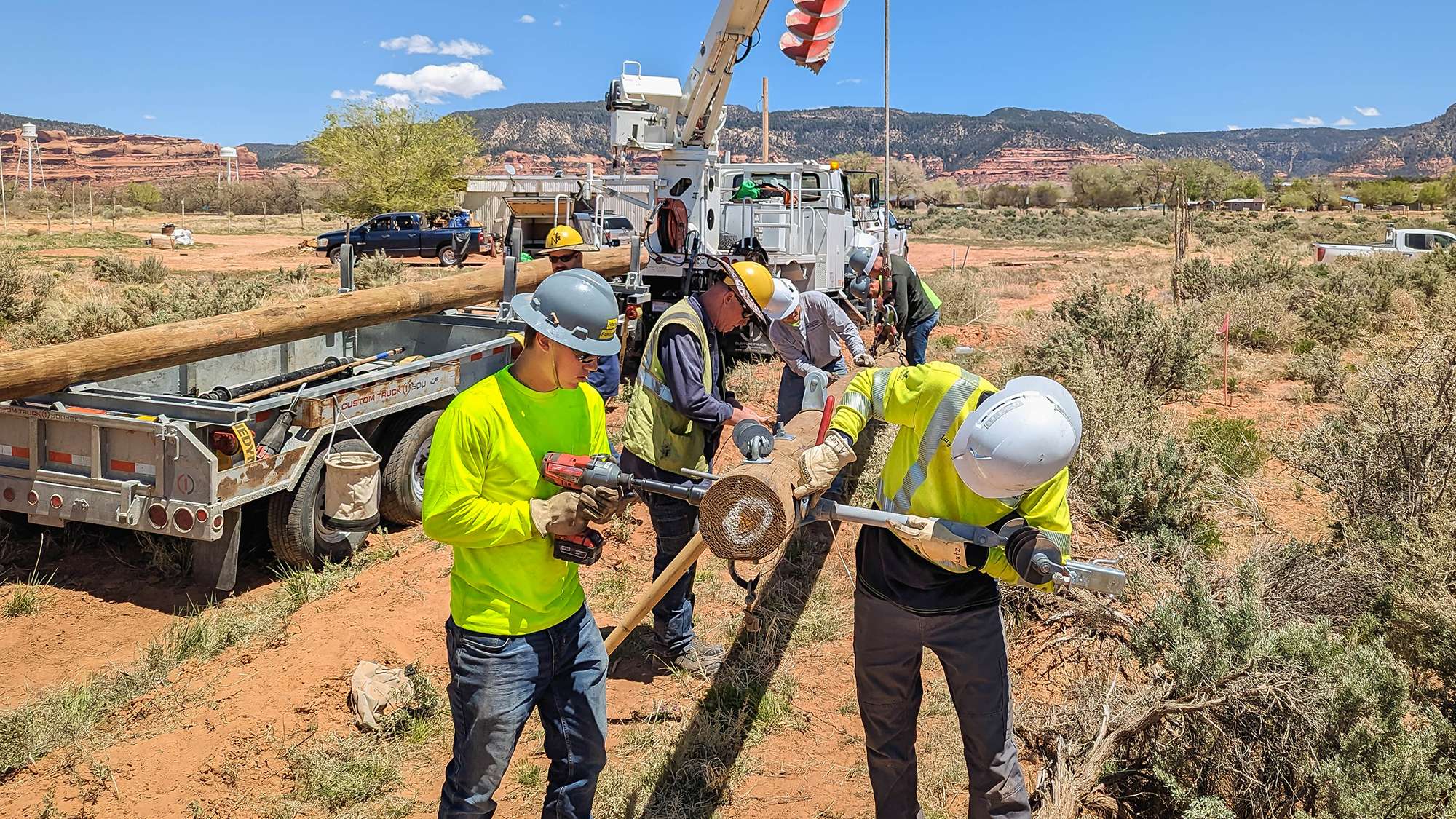 NTC lineman students constructing poles for power lines while working to bring power to the Navajo Nation.