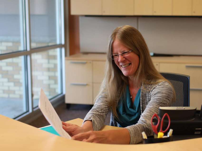 Businesswoman sorting papers at her desk