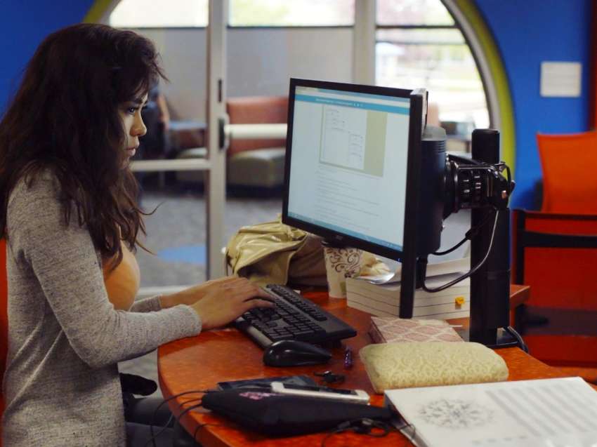 Student working on a computer in the NTC iTEC