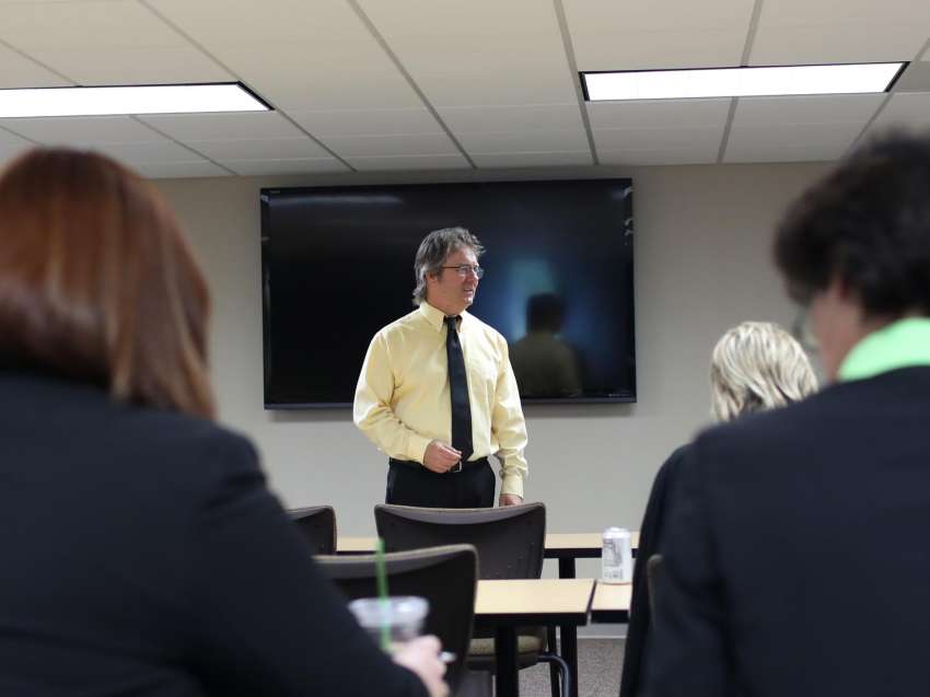 Business instructor teaching business people.