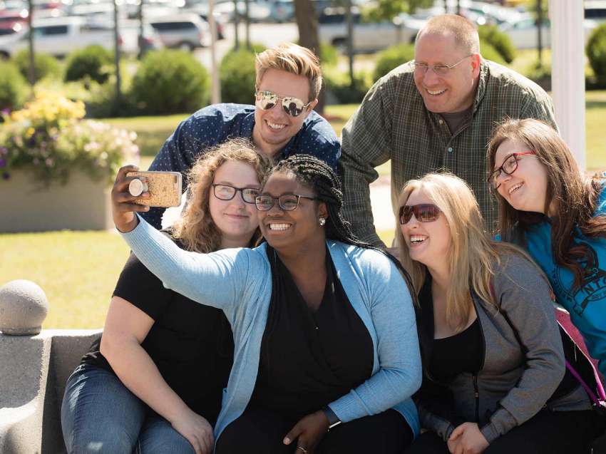 A group of students taking a selfie outside