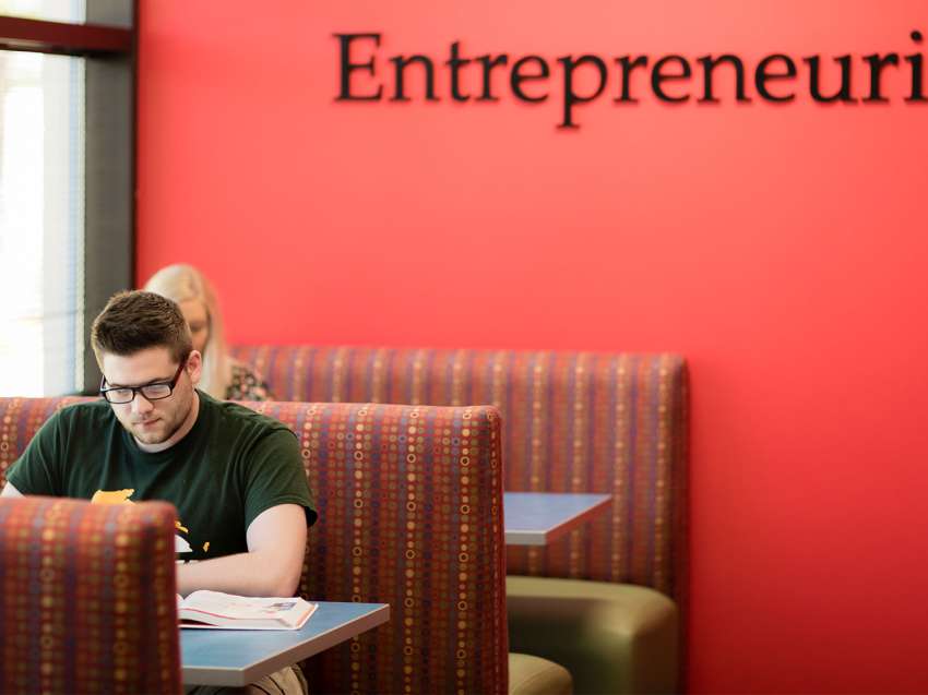 Students studying in booths just outside the Information Technology Entrepreneurial Center (iTEC)