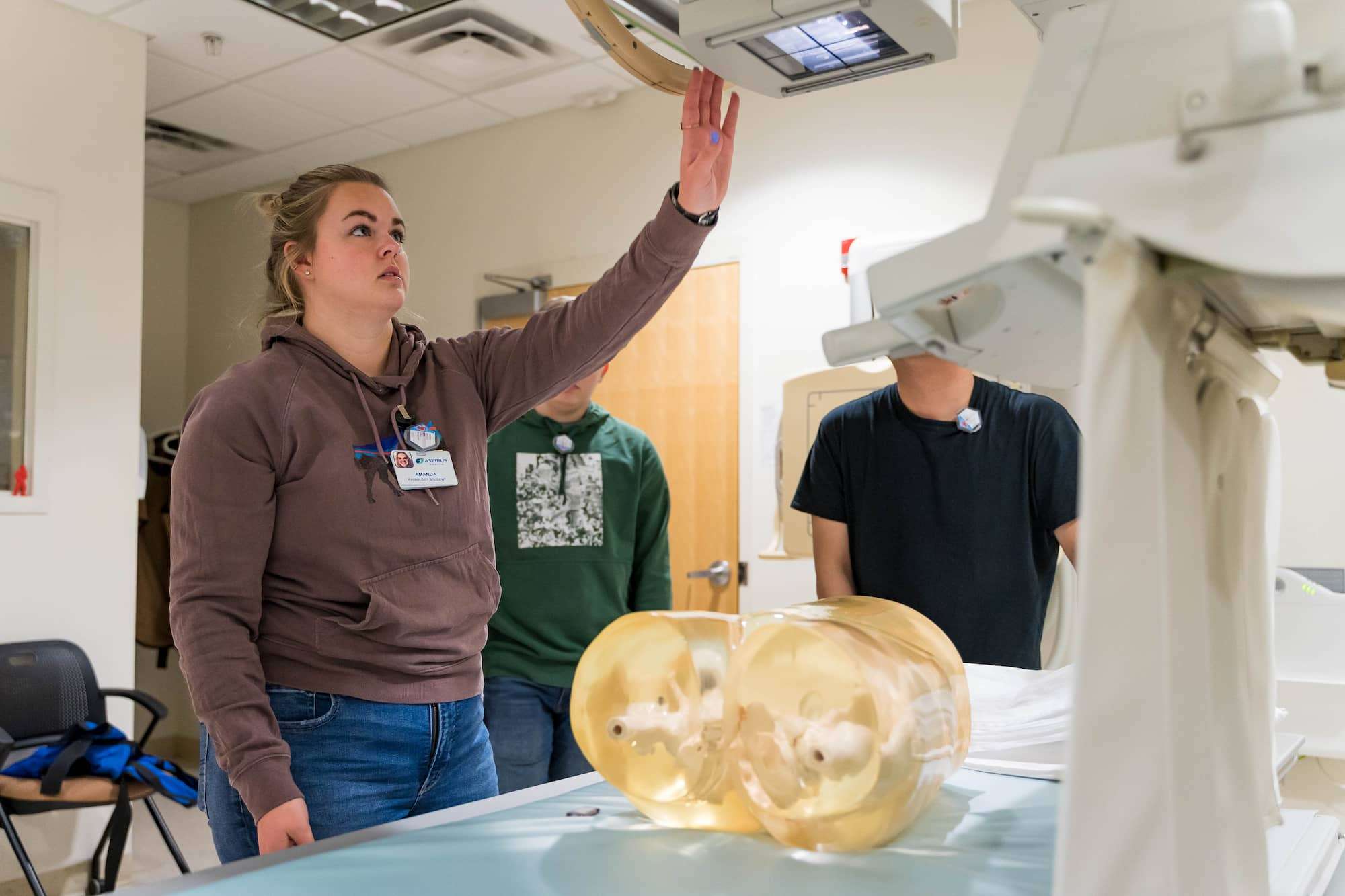 A student prepares a mannequin for x-rays of the hips and pelvis.